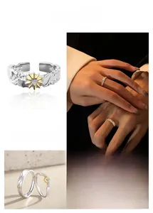 Detailed view of sun and moon couple rings featuring gold accents and textured open bands