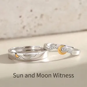 Adjustable sun and moon couple rings with gold-plated texture on matte stone surface