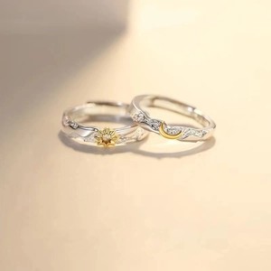 Macro view of sun and moon couple rings with hammered texture and zircon accents