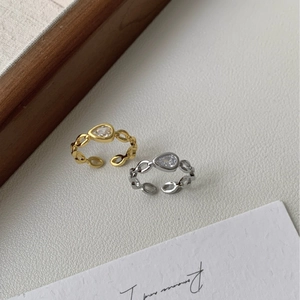 Elegant gold and silver chain link open rings featuring pear-cut cubic zirconia stones