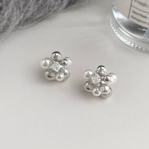 Exquisite floral stud earrings featuring white pearls and a central cubic zirconia stone
