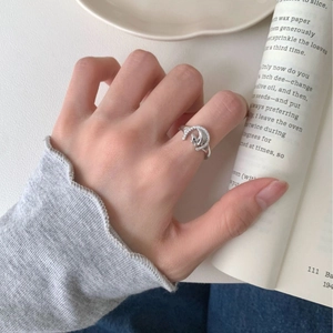 Silver crescent moon ring with sparkling zircons and a black cat silhouette design