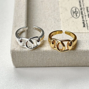 Detailed macro of gold and silver interlocking loop rings with polished finish
