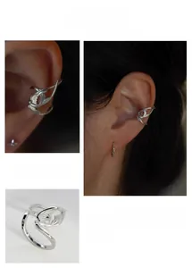 Detail of silver swallow ear cuff showing sleek bird design and clip-on style for non-pierced ears