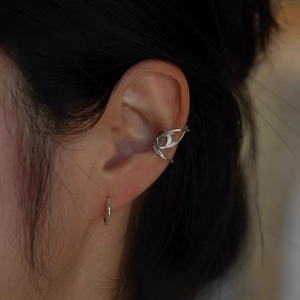 Exquisite swallow ear cuff with polished silver finish for non-pierced ears on a model