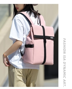 Pink business laptop backpack with black buckles shown in outdoor lifestyle scene