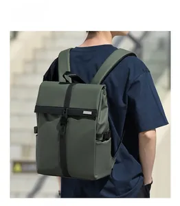 Olive green roll-top backpack with buckle straps and waterproof fabric on outdoor steps