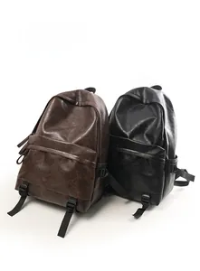 Detail view of vintage PU leather backpacks in brown and black with side buckles