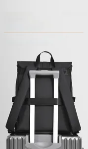 Detail showing the luggage strap feature on the back of the black waterproof business backpack