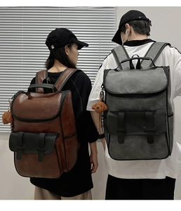 Close-up of matte PU leather backpacks with double buckles and plush dog charms