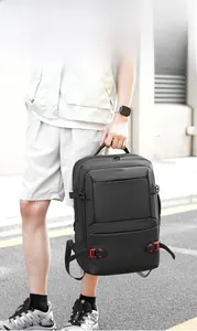 Detail of multi-pocket tactical backpack showing waterproof fabric and red buckle