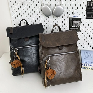 Minimalist PU leather backpack for men with plush teddy charm in black and brown colors
