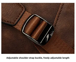 Detail of adjustable shoulder strap with brown lychee leather and black buckle hardware