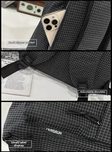 Detail of grid backpack featuring back anti-theft zipper pocket and adjustable straps