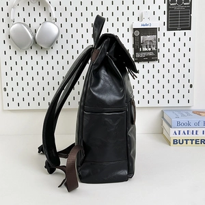 Black leather backpack with side pockets and brown straps for business and outdoor travel
