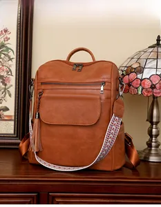 Sac à dos vintage en cuir PU marron avec sangle ethnique et détail de pompon latéral