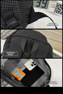 Detail of reinforced triangle stitching, wide handle, and spacious interior of plaid backpack