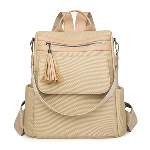 Beige tassel backpack with woven texture and leather trim on a plain white background