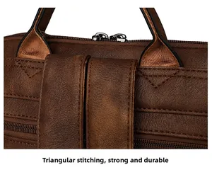 Detail of reinforced triangle stitching on the brown leather handle for durability