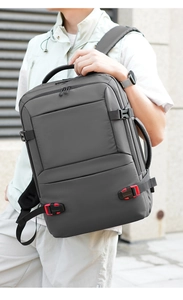 Detail showing durable gray fabric and red buckle on business laptop backpack side