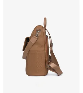 Side view of tan canvas backpack featuring leather trim and silver metal zipper details
