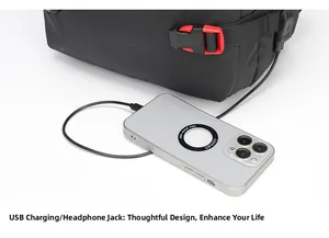 Detail of laptop backpack side with USB charging port and red buckle closure
