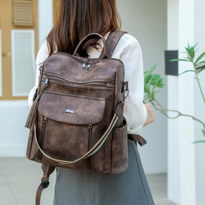 Deep brown faux leather backpack with multiple pockets and colorful woven strap accents