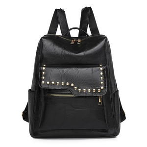 Detail of black PU leather backpack with leaf pattern embossing and gold studs