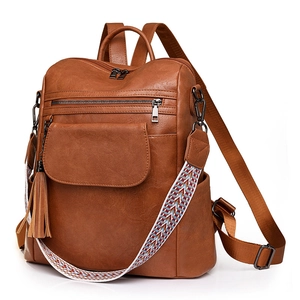 Sac à dos vintage en similicuir marron avec bandoulière tissée et pendentifs glands