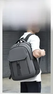 Detail view of water-resistant gray laptop backpack with multiple zipper compartments