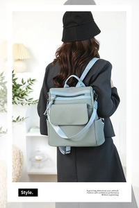 Detail of light blue-grey woven backpack texture on model in minimalist setting
