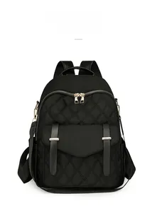 Détail du sac à dos en nylon matelassé noir avec boucle dorée et fermeture éclair fluide