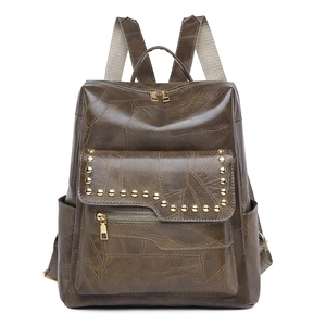 Detailed front view of brown PU leather backpack with vintage gold rivet decorations