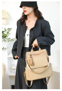 Beige woven texture backpack with leather fringe detail shown on a fashion model