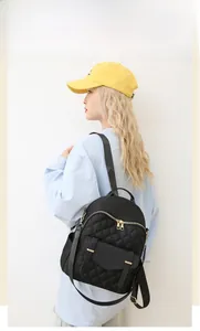 Détails du sac à dos noir en nylon matelassé avec fermetures éclair dorées élégantes