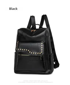 Detail of black PU leather backpack showing golden rivet studs and embossed texture