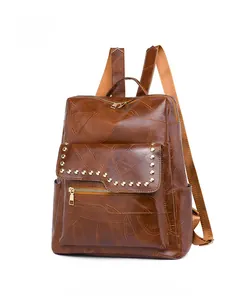 Brown vintage PU leather backpack with gold rivets and leaf vein texture detail