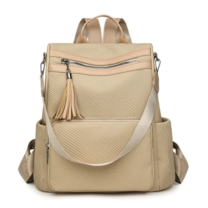 Minimalist beige woven backpack for women with decorative tassel and front zipper pocket