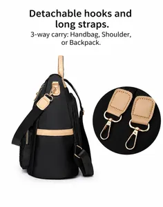 Details zum abnehmbaren goldenen Haken und der Seitentasche am schwarzen Nylonrucksack