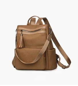 Close-up of brown woven fabric texture and leather tassel detail on versatile backpack