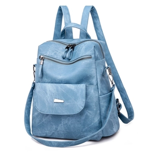 Detail of adjustable straps and side pockets on a blue PU leather backpack for women