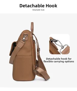 Detail of vintage brown textured backpack with a detachable metal hook for versatile carry