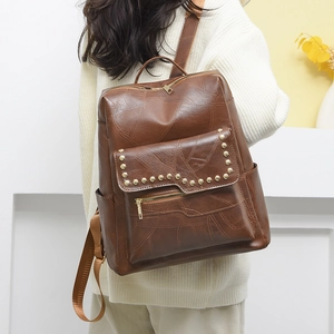 Brown PU leather backpack with vintage patchwork design and stylish gold rivets detail