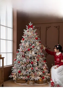 Detailed view of a 1.8m snow-flocked Christmas tree with red ornaments and warm LED lights