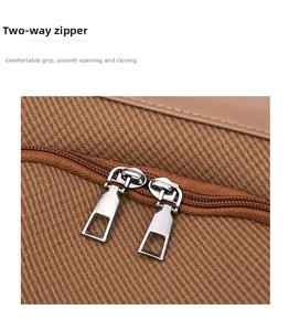 Close-up of durable two-way silver metal zippers on twill fabric backpack