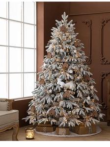 Close-up of premium snow-flocked Christmas tree with wooden house and squirrel ornaments