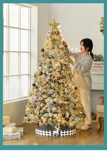 Close-up of 2.1m flocked Christmas tree with warm lights and golden ornaments