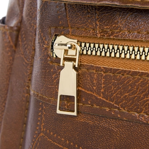 Macro shot of vintage brown PU leather texture and golden metal zipper detail
