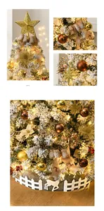 Detail of 2.1m snowy Christmas tree with warm LED lights, gold ornaments and white fence