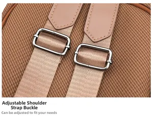 Macro detail of brown backpack showing adjustable metal buckle and nylon shoulder strap